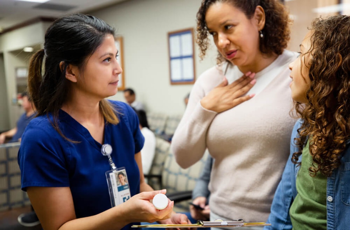 Spanish student listens to patients in waiting room.